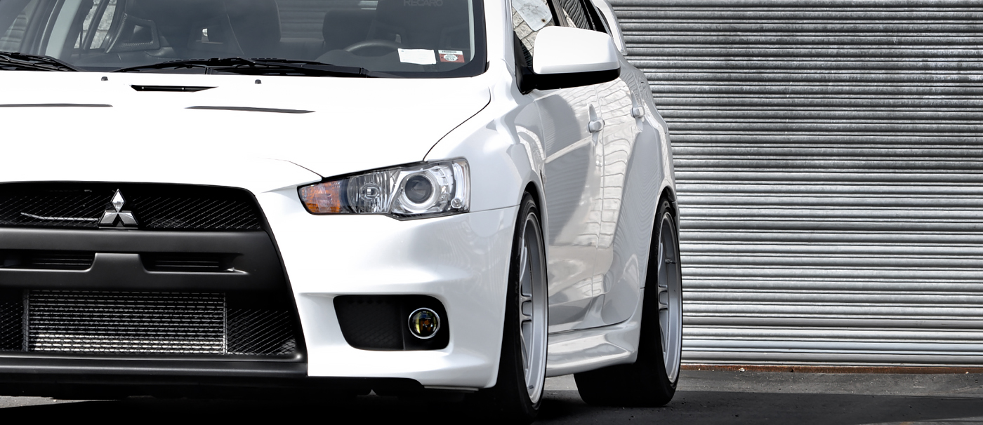 White Evo X lowered with Enkei RPF1 wheels